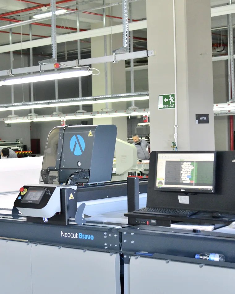 The automatic cutter and its control screen in the cutting room.