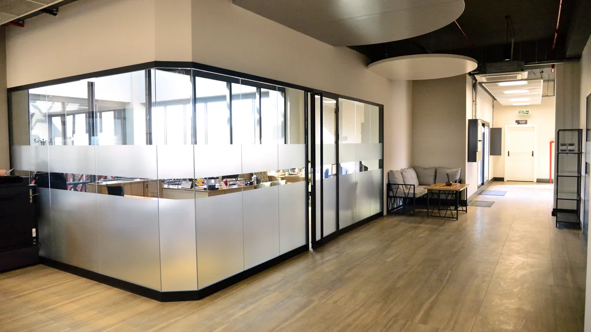 The management office, glazed rooms along an open corridor.