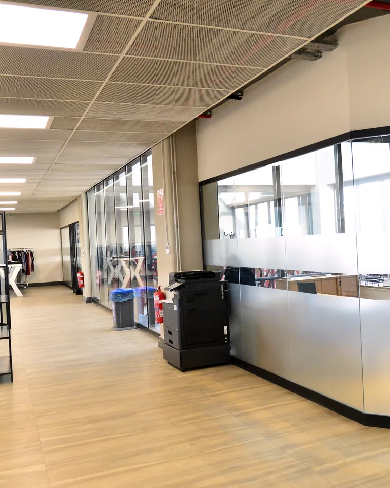 The management office, glazed rooms along an open corridor.